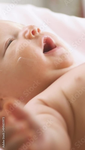 Mother applying moisturizing baby cream against dry skin. Concept of hygiene, baby care and healthcare.
