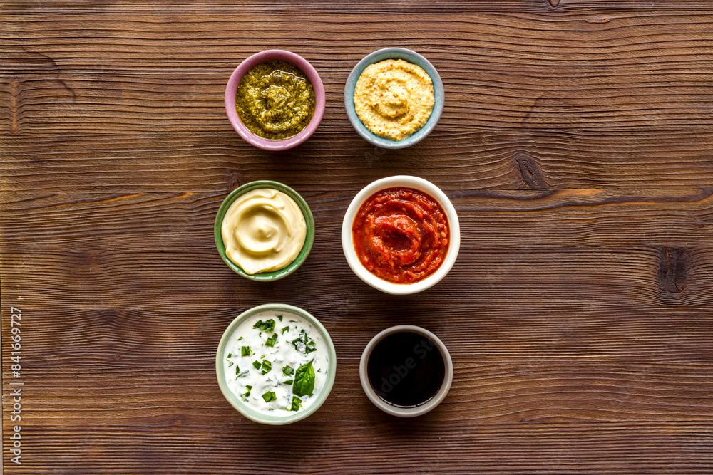 Set of sauces in bowls - pesto salsa mustard and others. Food background Set of sauces in bowls - pesto salsa mustard and others. Food background