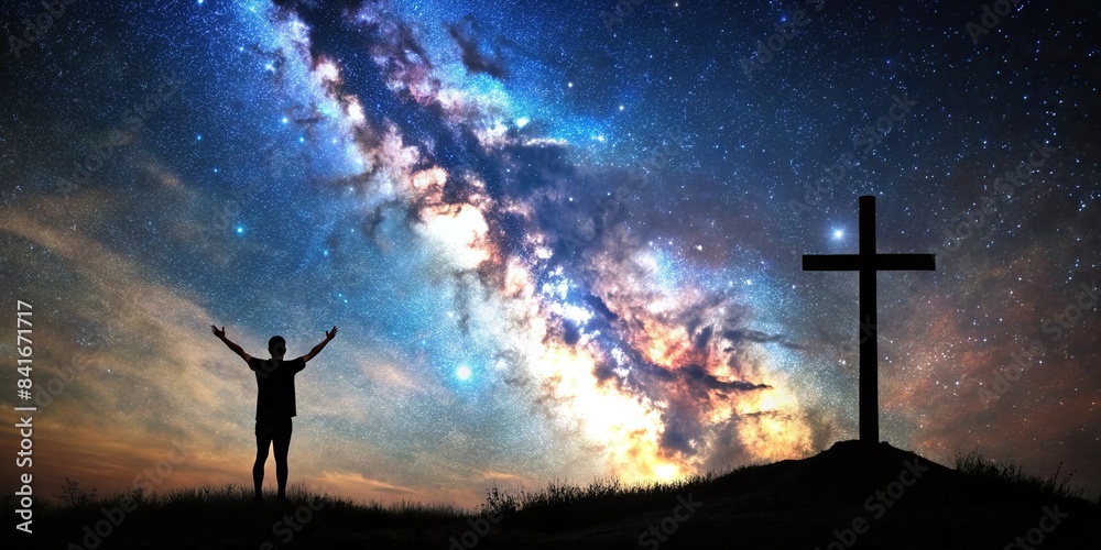 Christian cross symbol in the night sky with silhouette of person