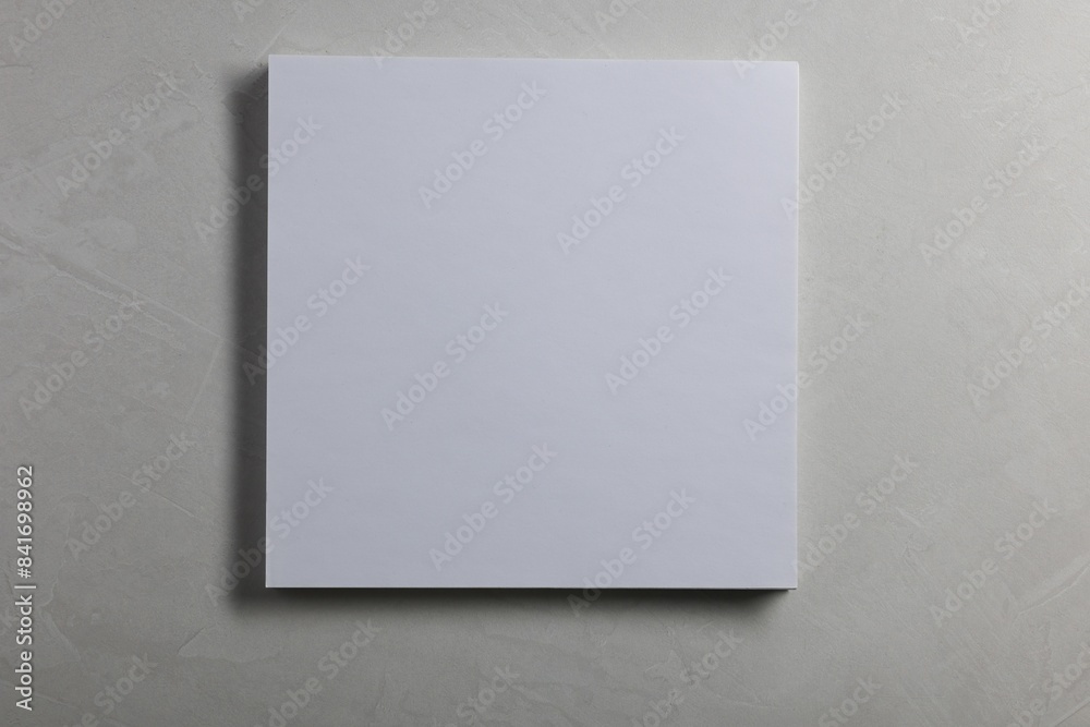 Blank paper sheets on grey textured background, top view. Mockup for design Blank paper sheets on grey textured background, top view. Mockup for design