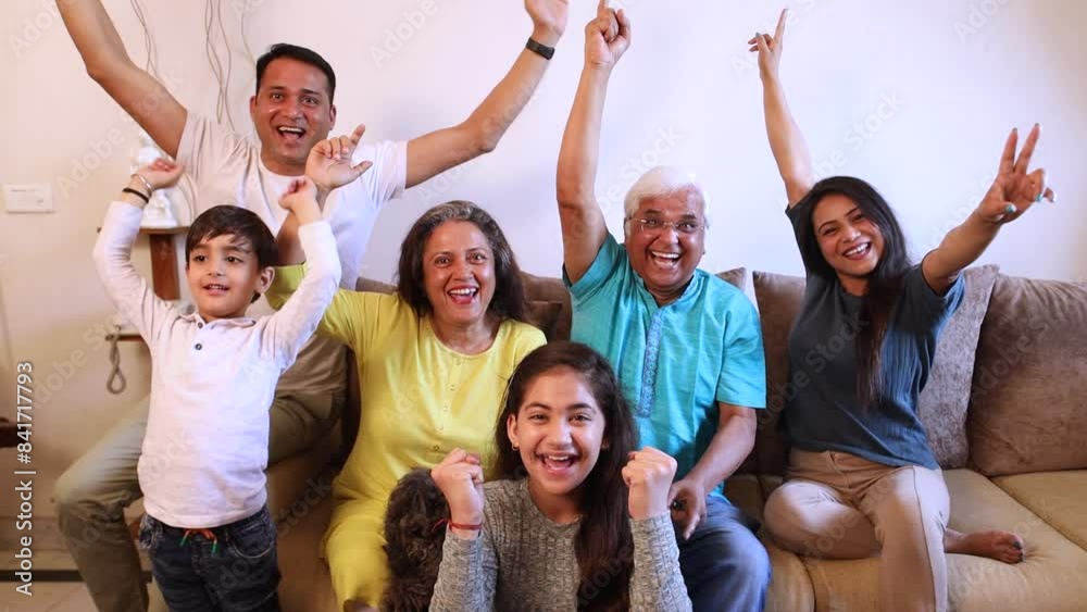 family sitting on sofa and watching Match and cheering family sitting on sofa and watching Match and cheering