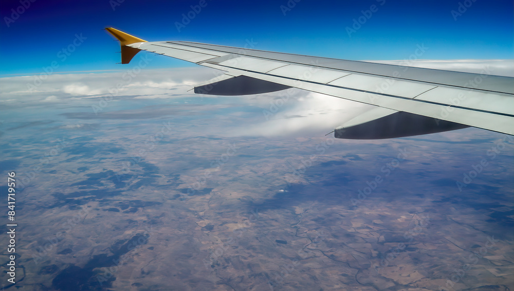 left wing of airplane flying above the clouds left wing of airplane flying above the clouds