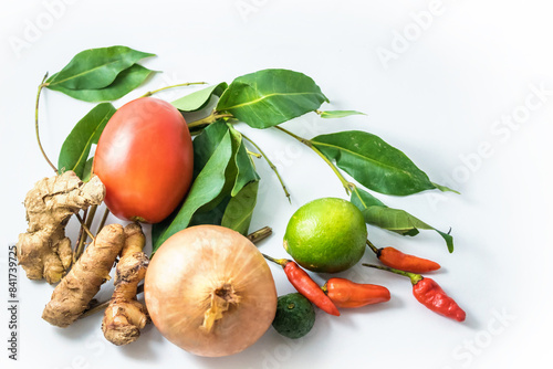 Indonesian typical vegetables and spices: ginger, curcuma, onion, key lime, chili, indonesian/indian bay leaf (daun salam), tomato; isolated on white photo