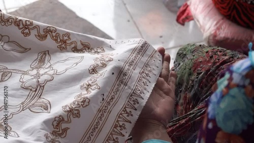 The technique of making batik by writing using a canting tool. Canting consists of nyamplung, cucuk, gagang or handles made of copper, bamboo and wax.  photo