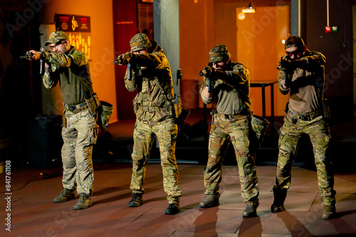 at a professional shooting range military trainers perform tactical exercises with NATO assault rifles