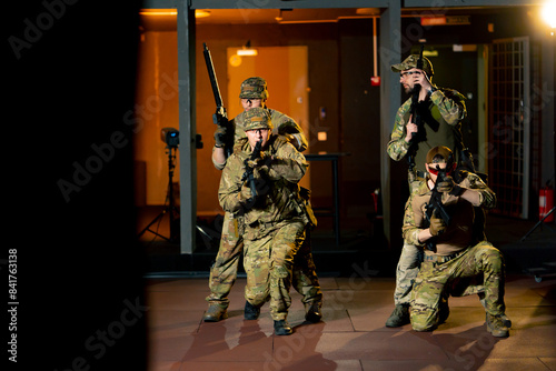 at a professional shooting range military trainers perform tactical exercises with NATO assault rifles