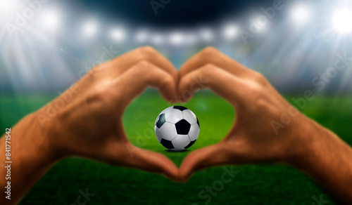 Herzhand mit Soccer Fussball im Stadion