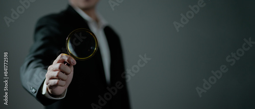 A man with a magnifying glass solves a mystery. Observation, attention to detail, and analytical thinking. Find clues, uncover hidden information. Patience, logical reasoning, systematic examination.