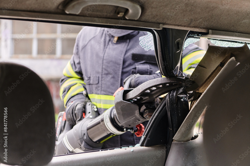 A dedicated team of professional firefighters employs specialized tools to cut and break through vehicle wreckage, showcasing their skilled collaboration and swift response in rescuing individuals A dedicated team of professional firefighters employs specialized tools to cut and break through vehicle wreckage, showcasing their skilled collaboration and swift response in rescuing individuals