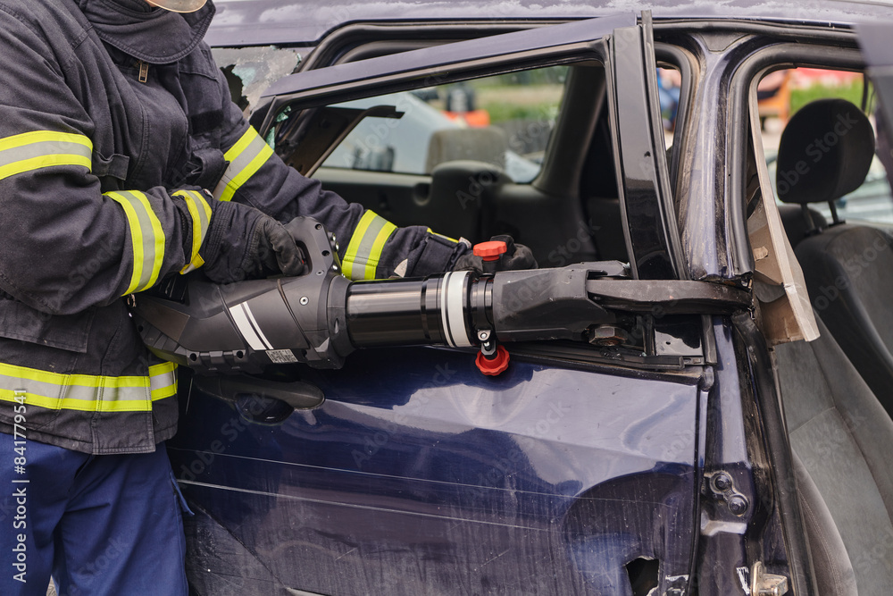 A dedicated team of professional firefighters employs specialized tools to cut and break through vehicle wreckage, showcasing their skilled collaboration and swift response in rescuing individuals A dedicated team of professional firefighters employs specialized tools to cut and break through vehicle wreckage, showcasing their skilled collaboration and swift response in rescuing individuals