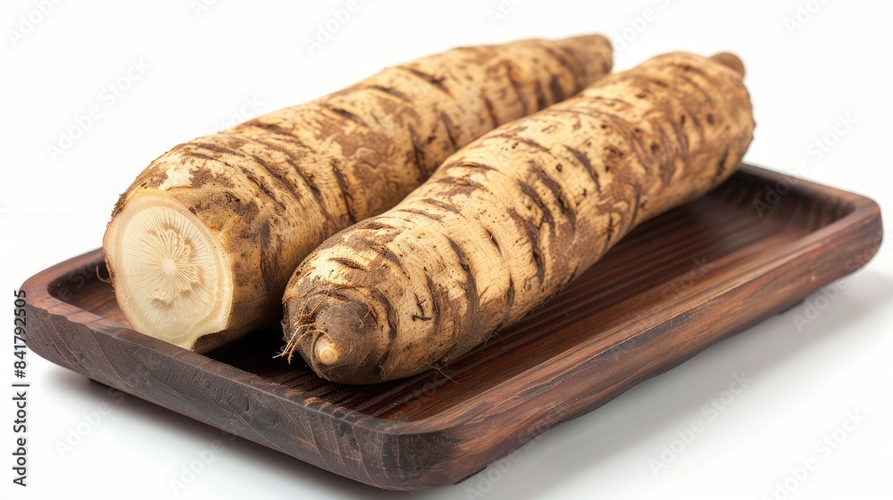Close up image of two horseradazh roots with a spicy taste on a wooden tray isolated on a white background Close up image of two horseradazh roots with a spicy taste on a wooden tray isolated on a white background