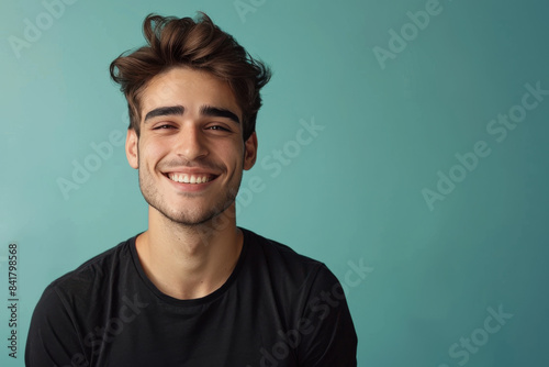 A close up portrait of a young man with a subtle smile