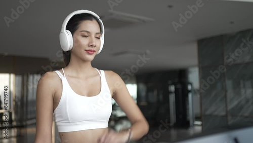 Pretty woman is exercising at high rise building fitness center.