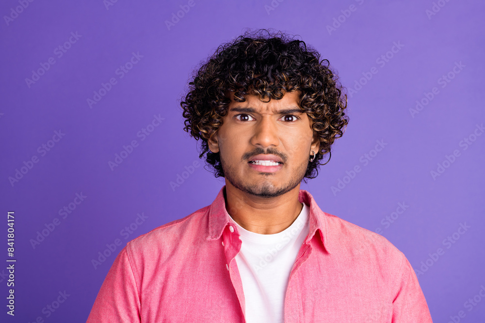 Portrait of nice young man grin teeth wear pink shirt isolated on purple color background Portrait of nice young man grin teeth wear pink shirt isolated on purple color background