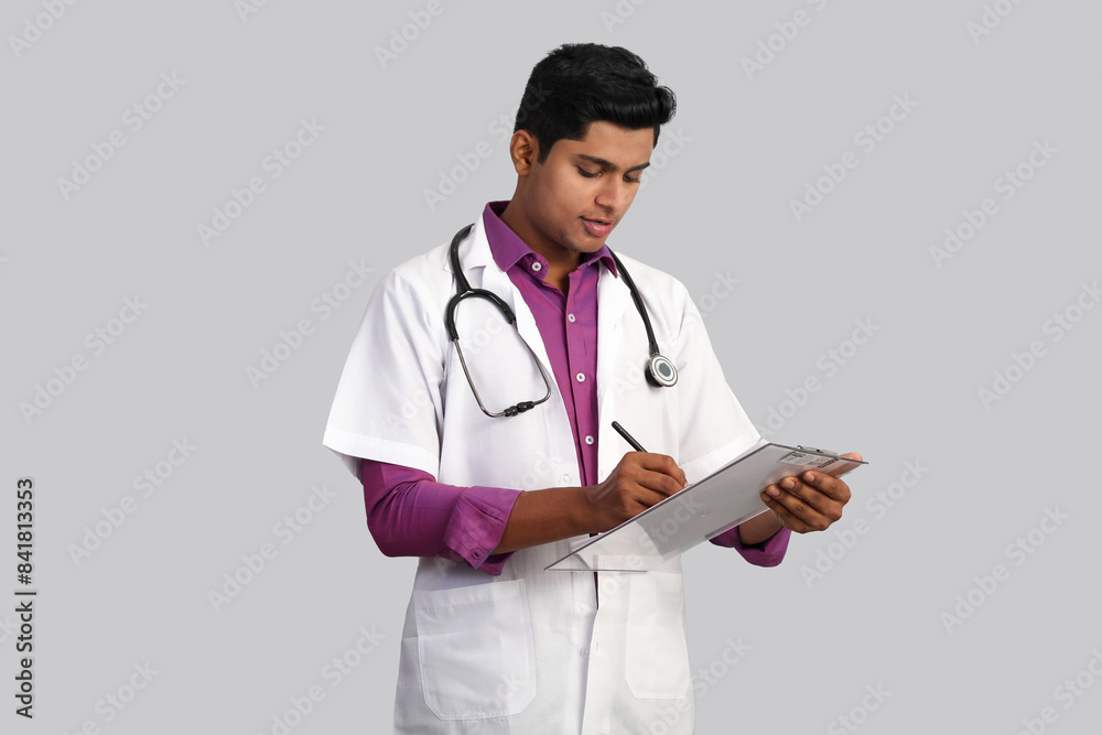 young handsome Indian male doctor with stethoscope on his neck, wearing gloves using tablet isolated on white background young handsome Indian male doctor with stethoscope on his neck, wearing gloves using tablet isolated on white background