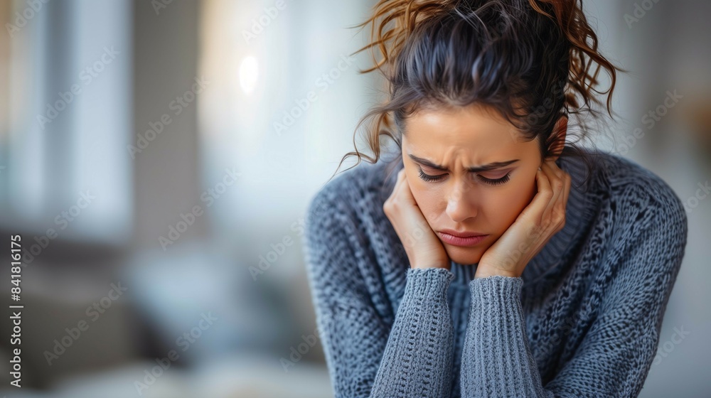 Young woman sad and depressed,holding head in hands,suffering from mental health issues. Young woman sad and depressed,holding head in hands,suffering from mental health issues.