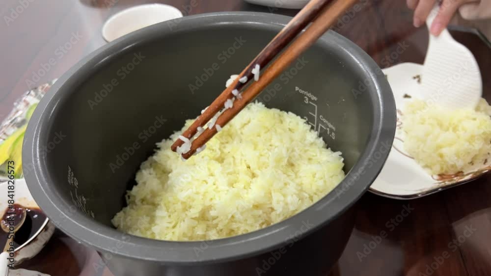 Japanese cook expertly takes ball of rice from rice cooker mesmerizing process unfolds revealing artistry of rice preparation Immerse yourself in world of rice where each grain. tells flavorful story Japanese cook expertly takes ball of rice from rice cooker mesmerizing process unfolds revealing artistry of rice preparation Immerse yourself in world of rice where each grain. tells flavorful story