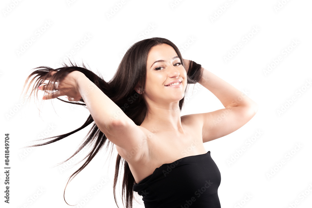 Young woman with long dark hair. Standing confidently in against white background throwing hair in the air. Young woman with long dark hair. Standing confidently in against white background throwing hair in the air.