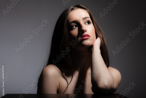 Beautiful girl studio portrait against dark background. photo
