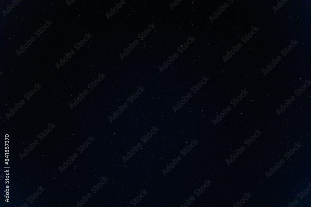 Fototapeta premium Breathtaking view of the night sky peppered with stars above the Wadi Rum desert of Jordan in April