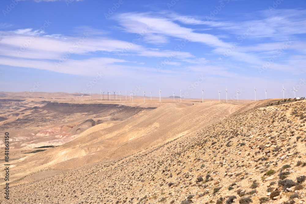 Wind turbine farm in remote arid desert environment generating renewable energy in Jordan, Middle East Wind turbine farm in remote arid desert environment generating renewable energy in Jordan, Middle East