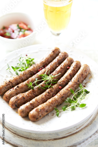 Roasted white sausages on bright wooden background. Copy spaces.
