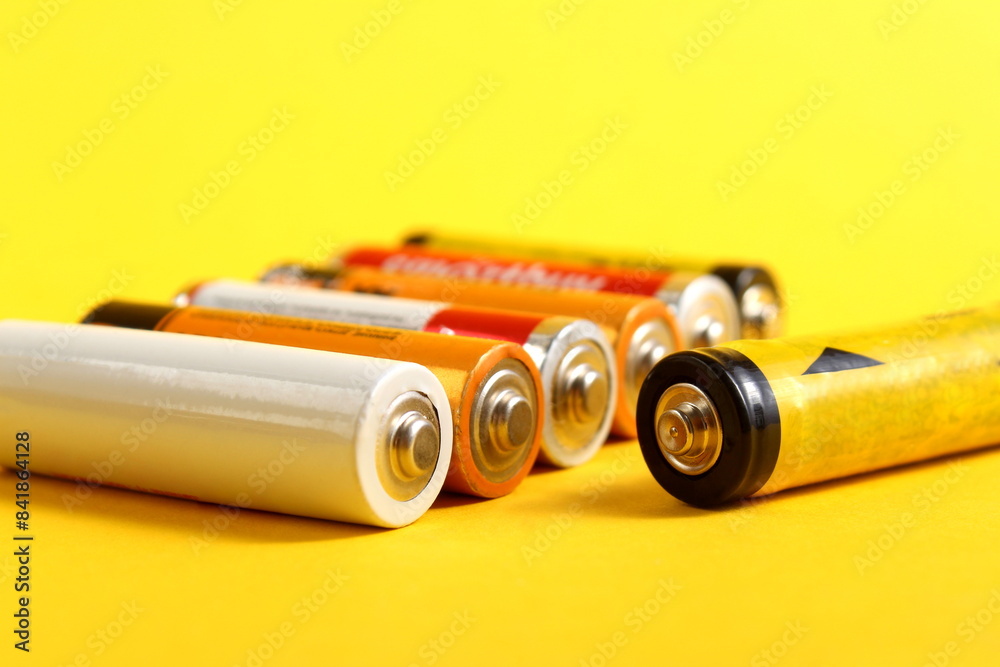 Ταπετσαρία A pile of salt batteries lie on a yellow background.