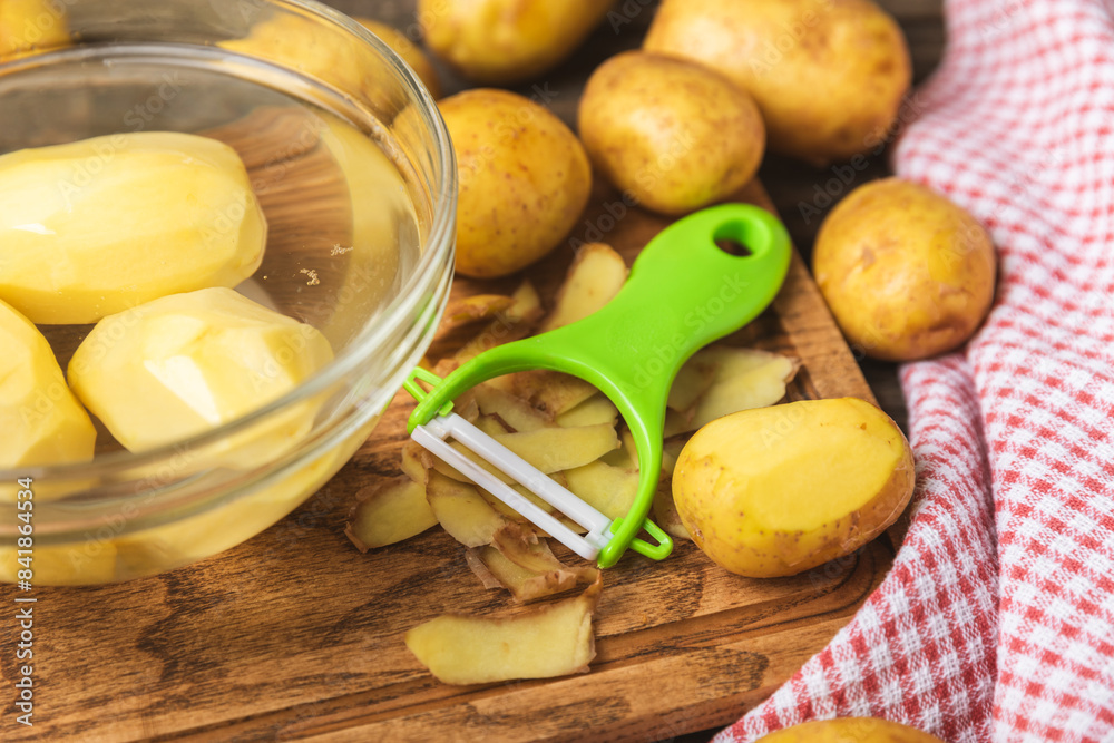 Young potatoes. Raw potatoes and knife on a wooden background.Peel potatoes.Harvesting collection. organic, freshly dug potatoes. Agricultural background. Vegan. Vegetables.Place for text.Copy space Young potatoes. Raw potatoes and knife on a wooden background.Peel potatoes.Harvesting collection. organic, freshly dug potatoes. Agricultural background. Vegan. Vegetables.Place for text.Copy space
