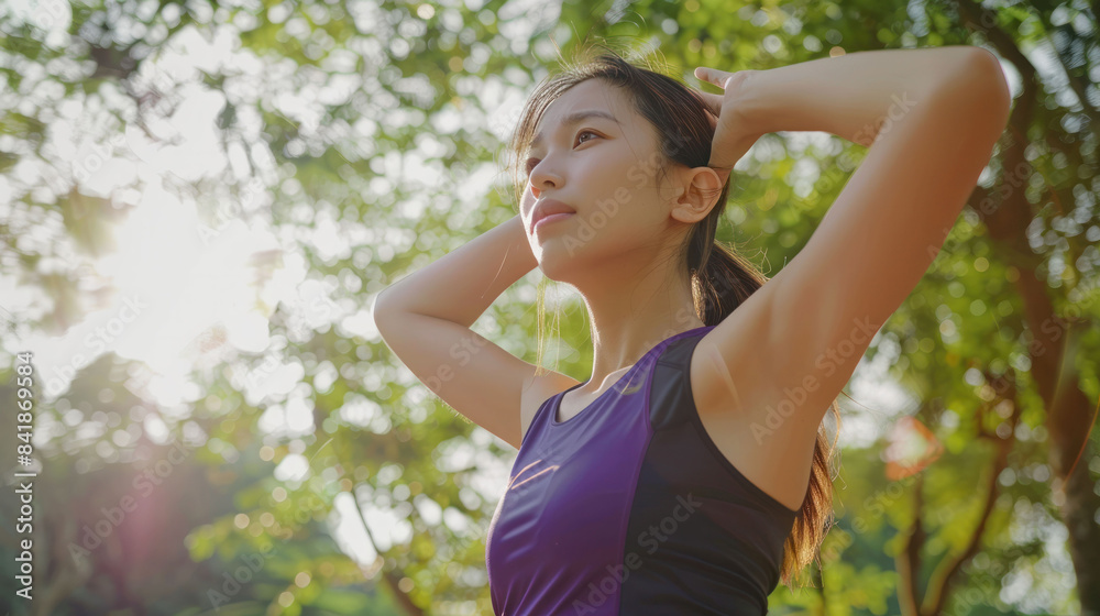 Female jogger. Fit young Asian woman with purple sportswear stretching muscle in park before running and enjoying a healthy outdoor. Fitness runner girl in public park. Wellness being concept Female jogger. Fit young Asian woman with purple sportswear stretching muscle in park before running and enjoying a healthy outdoor. Fitness runner girl in public park. Wellness being concept