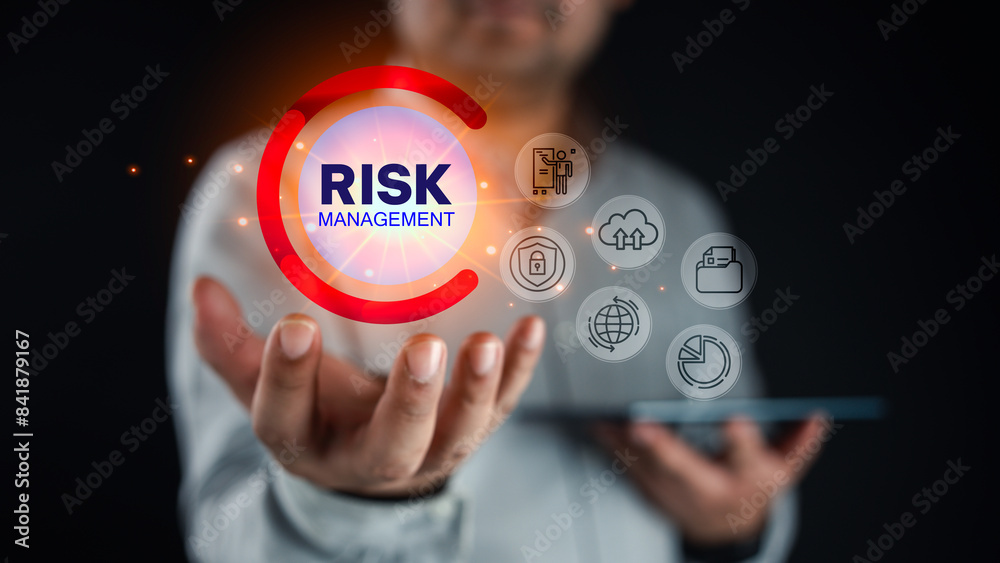 Businessman hand using a digital tablet with a virtual panel of icon interface of risk management, business concept, Risk management and assessment for business investment. Businessman hand using a digital tablet with a virtual panel of icon interface of risk management, business concept, Risk management and assessment for business investment.
