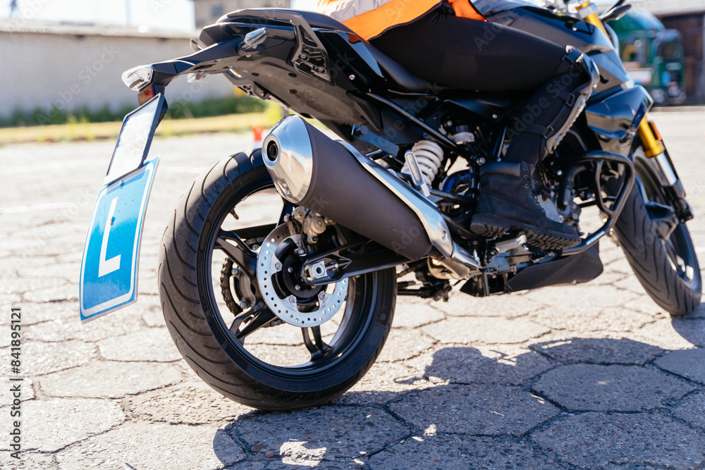 Obraz premium Female student moto school learning to ride a motorcycle.