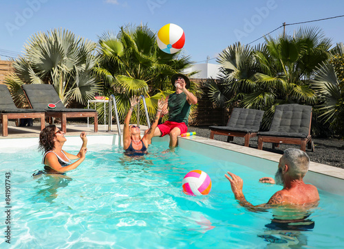 Fun pool day with friends enjoying a beach ball game