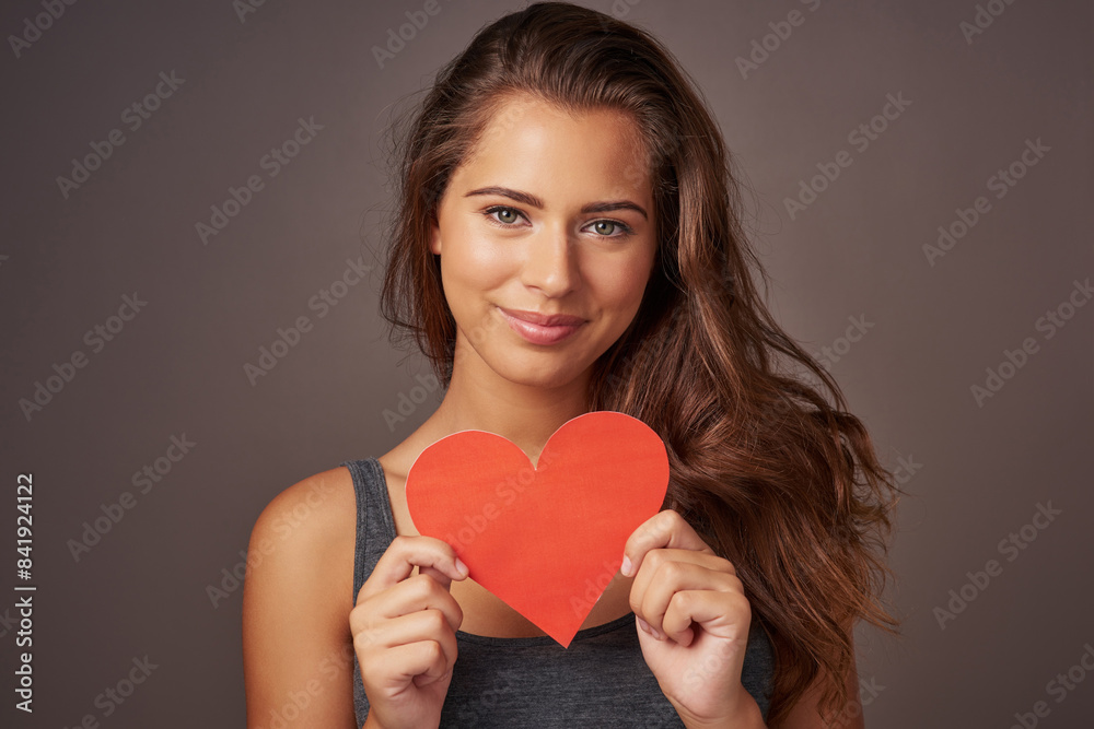 Portrait, love and woman with paper heart in studio for romance, support or donation isolated on background. Face, care and happy model with sign for valentines day, kindness or emoji for affection Portrait, love and woman with paper heart in studio for romance, support or donation isolated on background. Face, care and happy model with sign for valentines day, kindness or emoji for affection