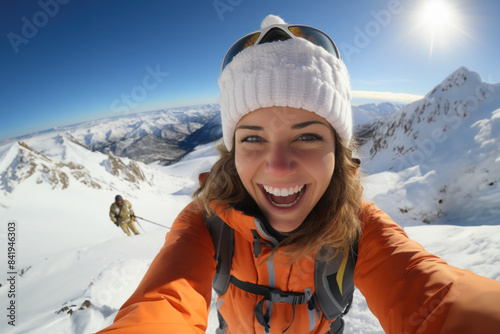 Portrait of a beautiful woman taking a selfie in the snow on a mountain at winter