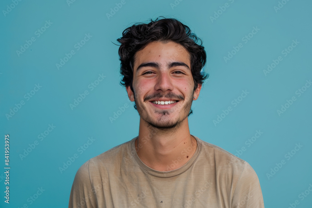 A close up portrait of a young man with a subtle smile
