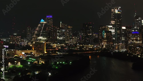 Wallpaper Mural Aerial night view of Austin, Texas cityscape with illuminated skyscrapers, vibrant lights, and a serene river reflecting the city's glow Torontodigital.ca