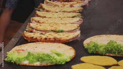 Italian flatbread called Piadina Romagnola or Spianata Bolognese being cooked on a very hot griddle