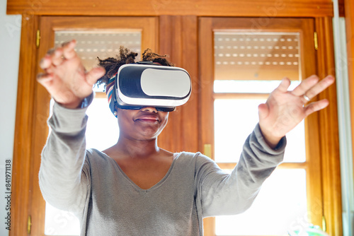 Young black woman testing a virual reality device. photo