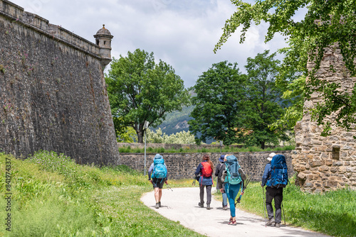 Obraz na plátně Way of St. James. Group of pilgrims on the Walls of Pamplona