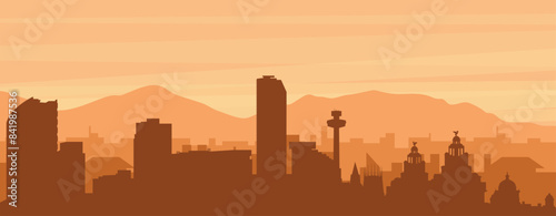 Brown panoramic poster of the city skyline with misty background buildings, sunrise, clouds and mountains of LIVERPOOL, UNITED KINGDOM © Sanja