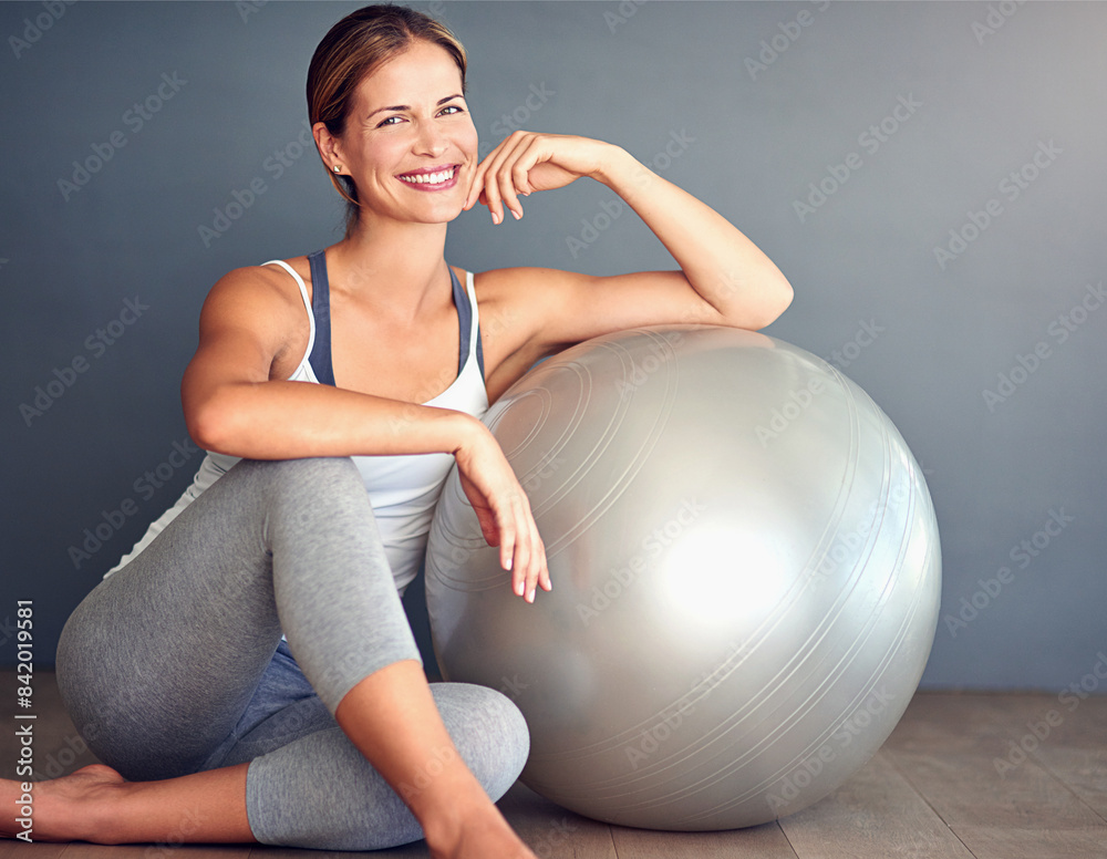 Ball, fitness and portrait of woman on floor in studio with gray background for workout. Exercise, health or smile and happy person with equipment for physical improvement, training or wellness Ball, fitness and portrait of woman on floor in studio with gray background for workout. Exercise, health or smile and happy person with equipment for physical improvement, training or wellness