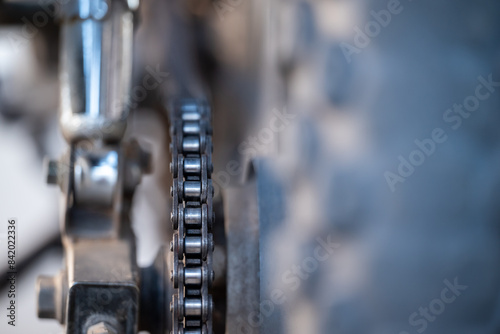 Fotografie Close up of motorbike chain. Dirty motorbike chain on rear wheel