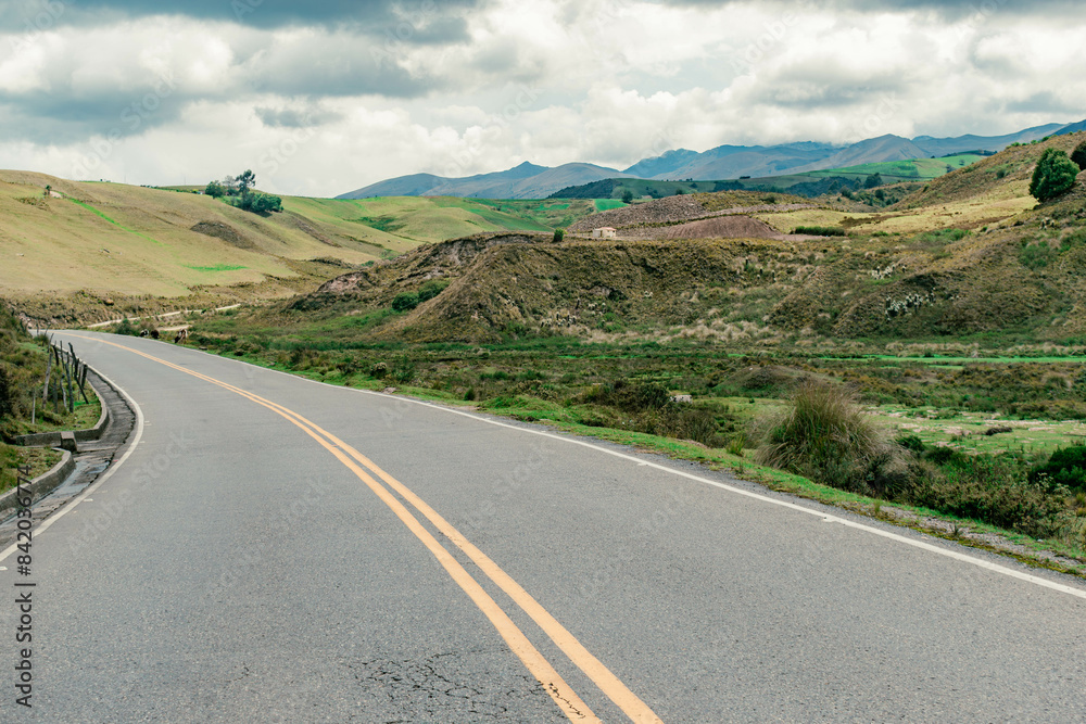 Fototapeta premium mountainous landscape with a road that disappears into the horizon