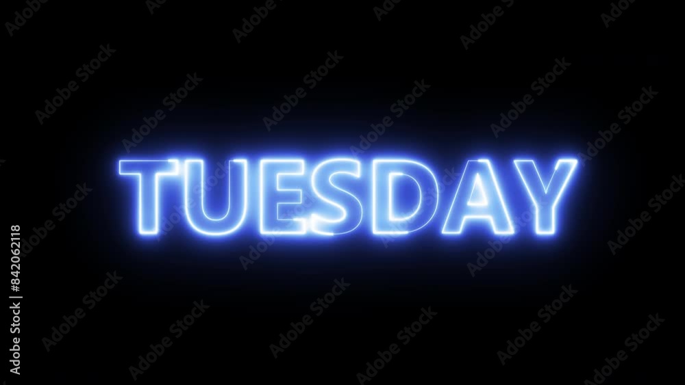 Glowing and flickering neon TUESDAY sign in blue on black. Written in capital letters and a variety of motion and brightness. Glowing and flickering neon TUESDAY sign in blue on black. Written in capital letters and a variety of motion and brightness.