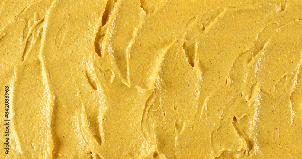 Yellow mustard sauce, spread background and texture, top view Yellow mustard sauce, spread background and texture, top view