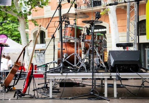 small concert stage with music instruments and no people at a street festival outdoors in Barcelona