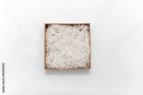 Cardboard box with decorative fillers for your product. Flat lay; top view; empty space for products