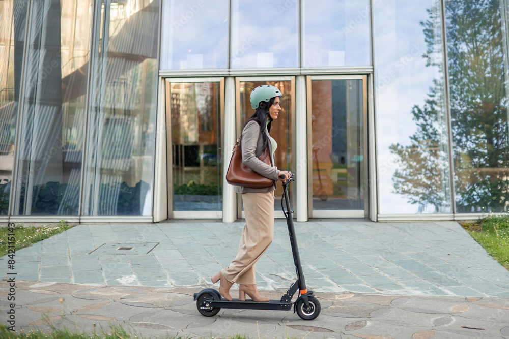Businesswoman Commutes to Work Sustainably on Electric Scooter Businesswoman Commutes to Work Sustainably on Electric Scooter