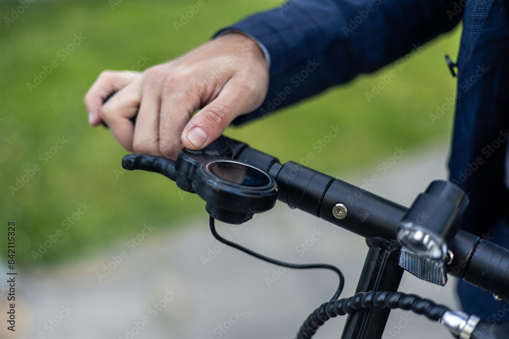 closeup Eco-Friendly Commute: Close-Up of Businessman's Hand on Electric Scooter Handlebar closeup Eco-Friendly Commute: Close-Up of Businessman's Hand on Electric Scooter Handlebar