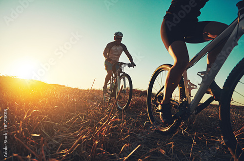 Wallpaper Mural Sunset sky, people and friends on bicycle with fitness, race and adventure trail in nature together. Cycling, exercise and team with mountain bike in evening for outdoor workout, sun and countryside Torontodigital.ca